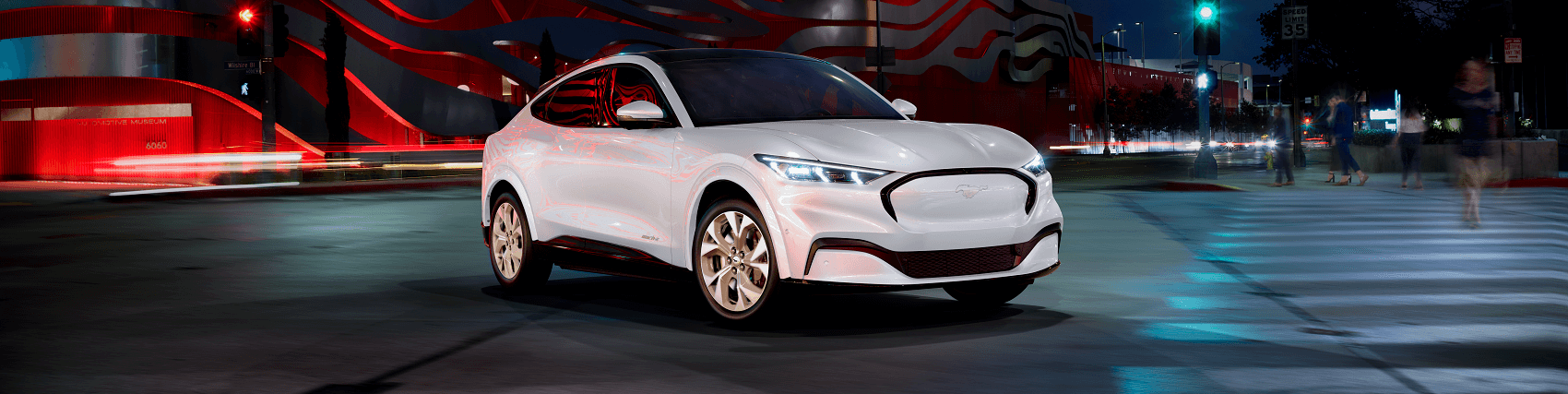 Ford Mustang Mach-E parked in the middle of city street with motion blur