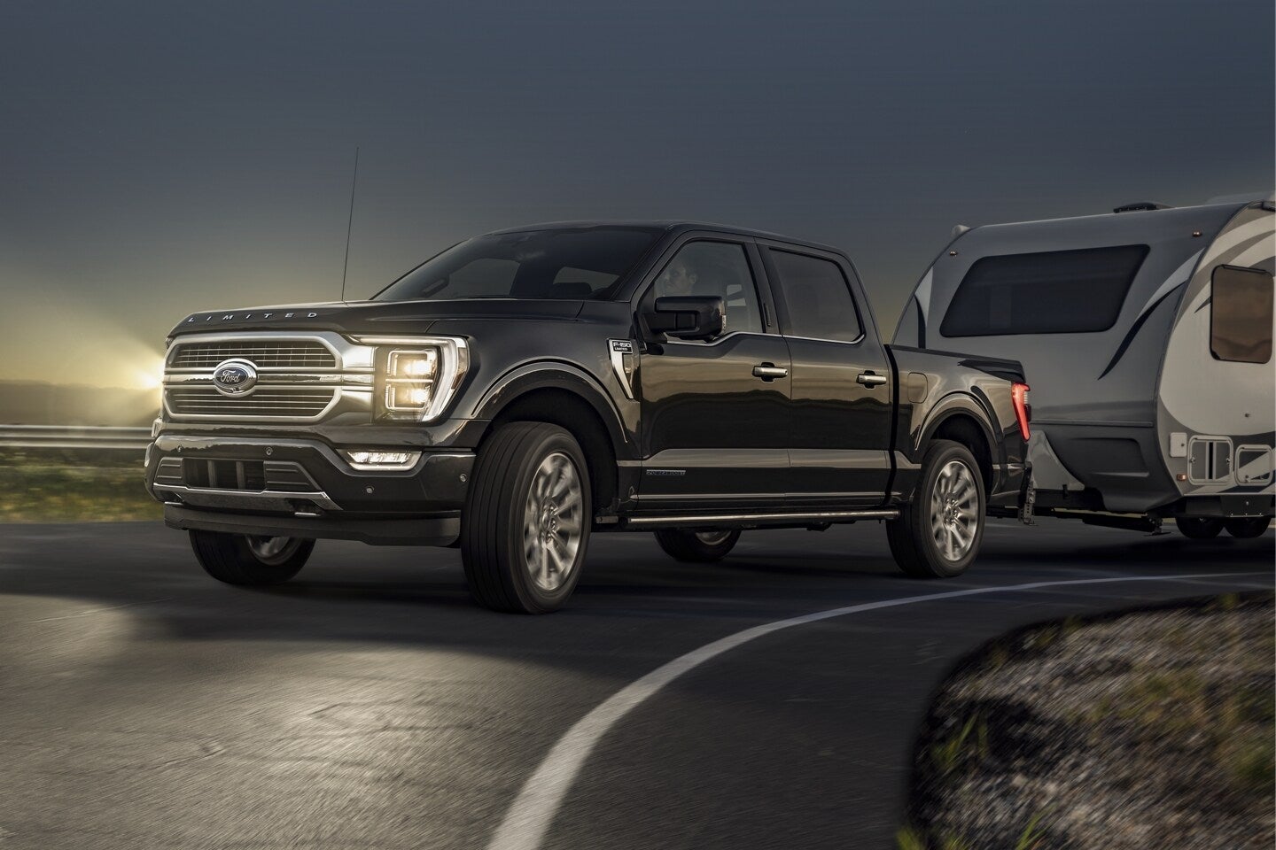 a black truck towing a trailer