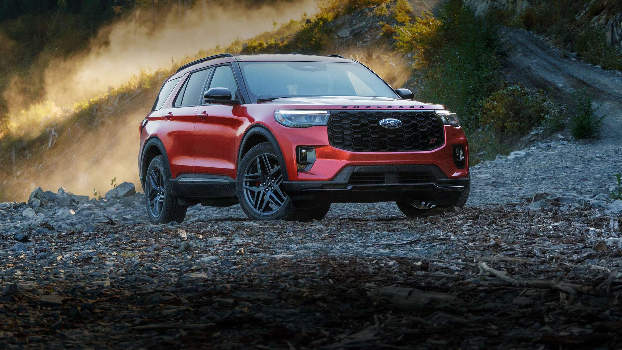 a blue suv parked in a field