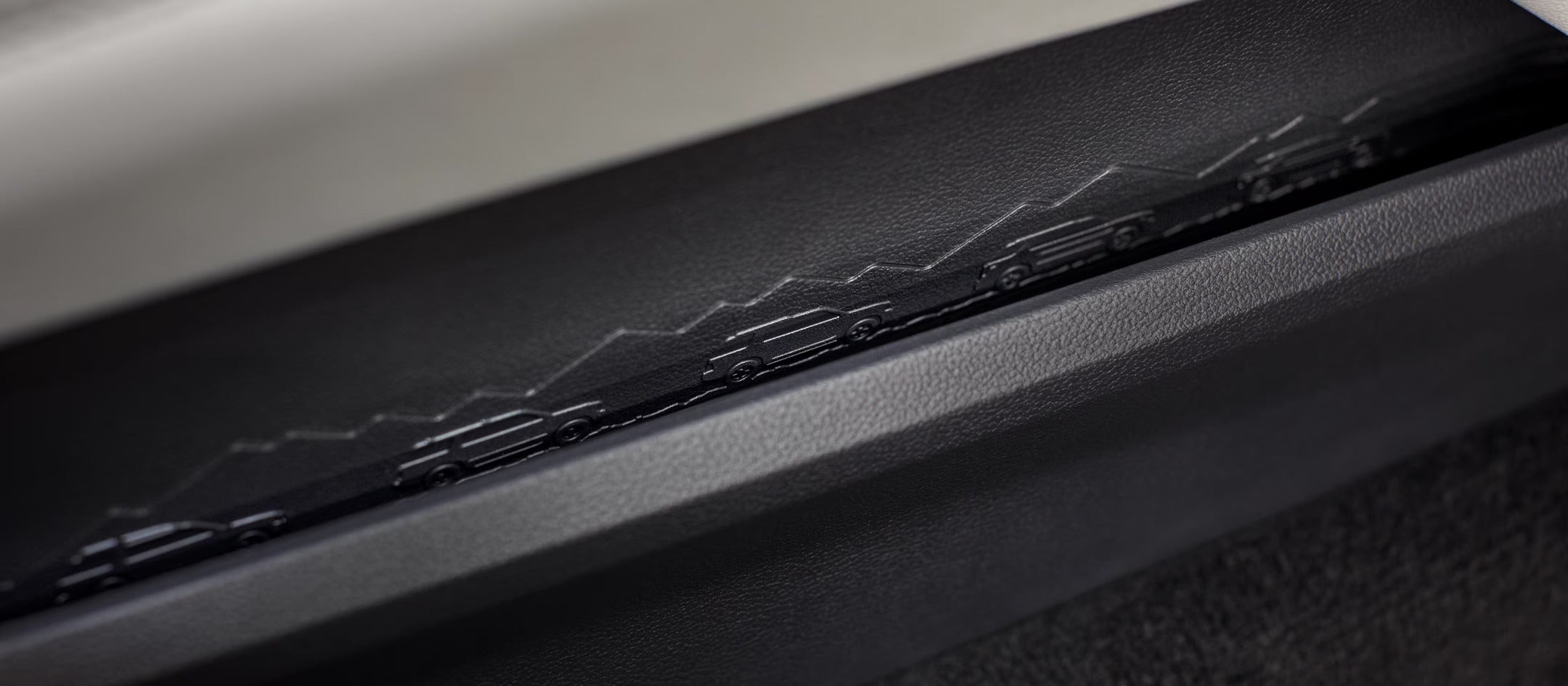 Detailed close-up of the mountain-themed design on the door trim inside the 2025 Ford Explorer.