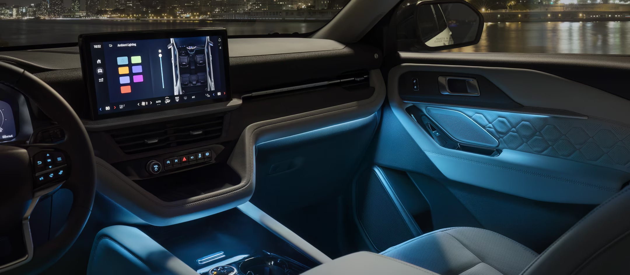 Interior view of the 2025 Ford Explorer showcasing the ambient lighting system and digital touchscreen.