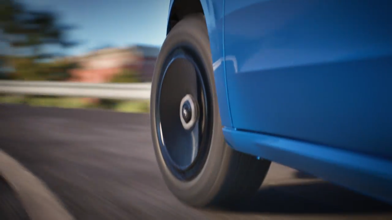 A close-up view of the Ford Maverick’s black wheel in motion, emphasizing the vehicle's style and performance on the road.