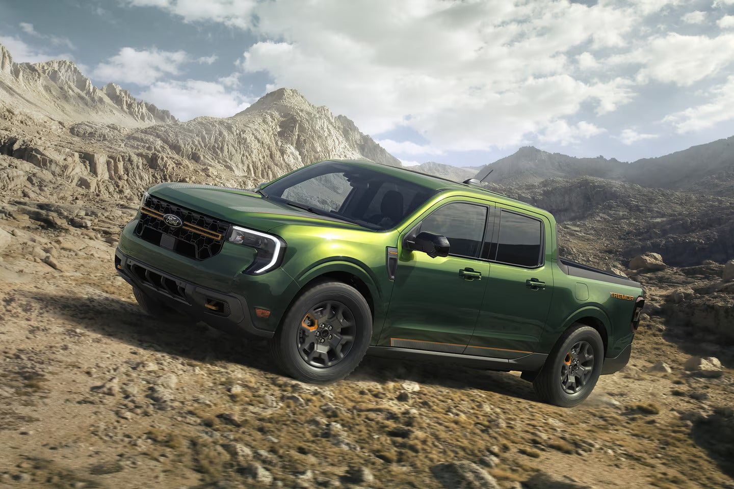 a green 2025 ford maverick truck driving up dirt