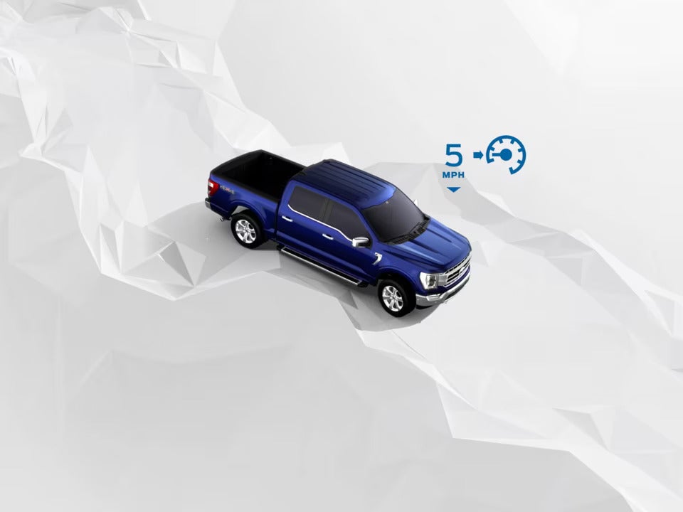 A graphic of a blue Ford Maverick illustrating its Hill Descent Control feature, with an icon indicating a controlled speed of 5 mph on a sloped terrain.