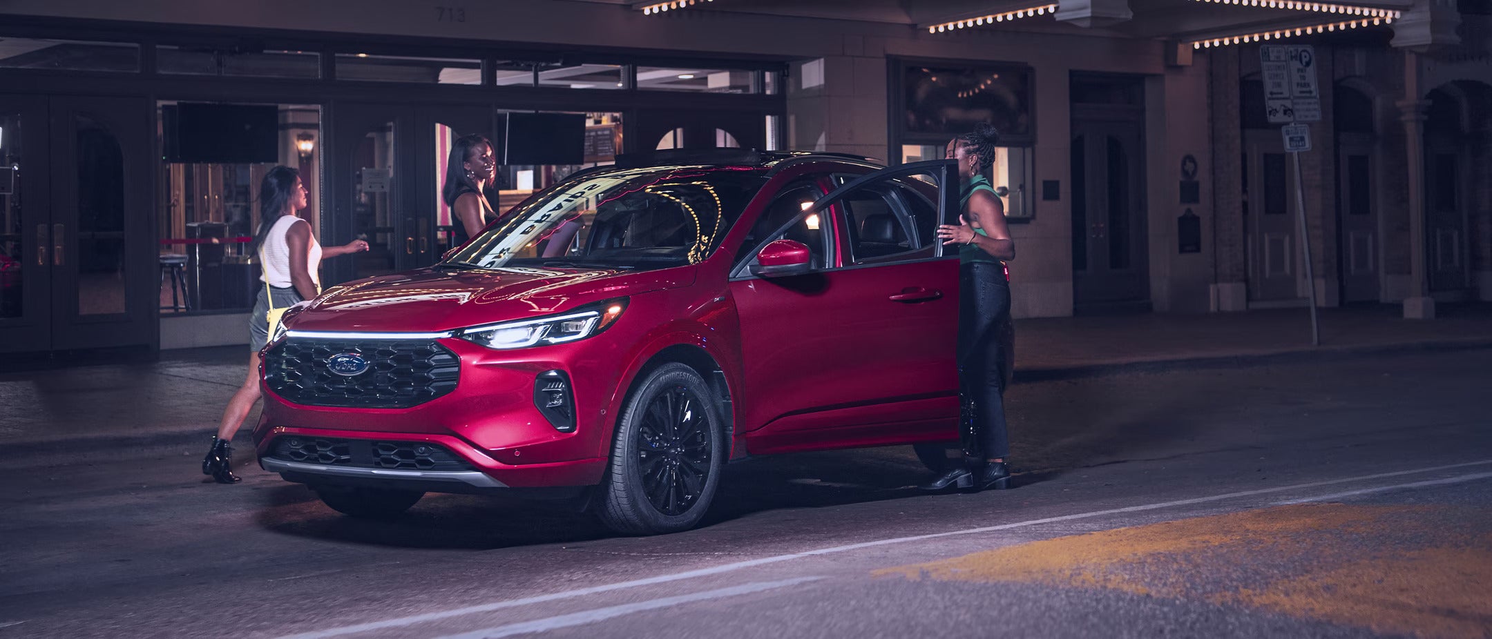 a red suv parked next to a store