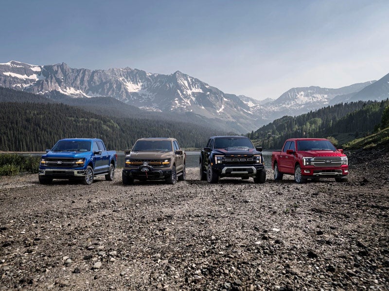 Line-up of Ford Electric trucks parked in the mountains from Ford Electric vehicle dealership in Broken Arrow, OK