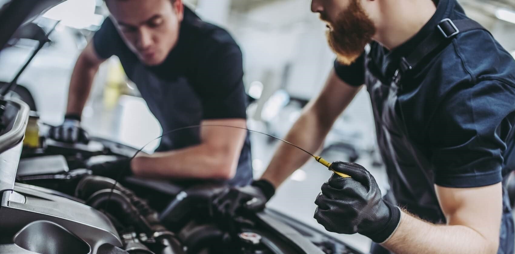 Mechanics performing oil change